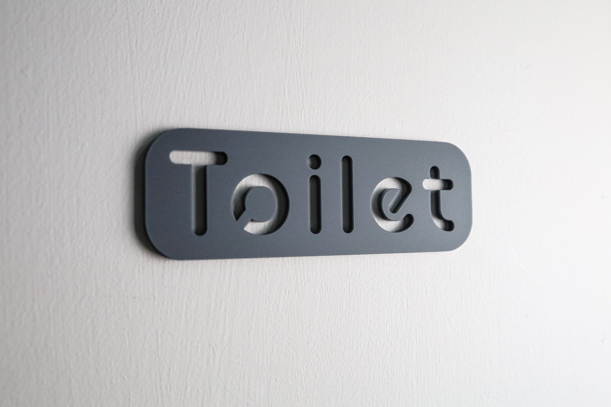 Elegant WC door sign featuring a refined stone texture finish and minimalist design.